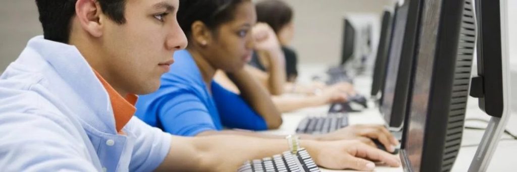 Young Man in High School Computer Lab